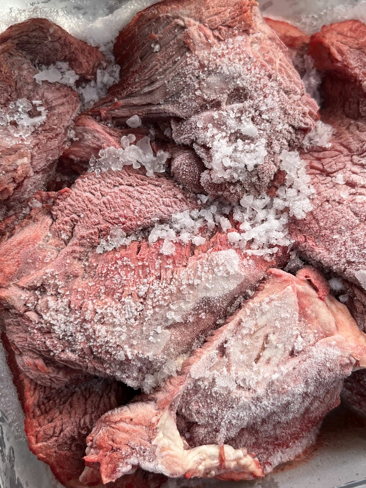 Frozen meat with visible ice crystals