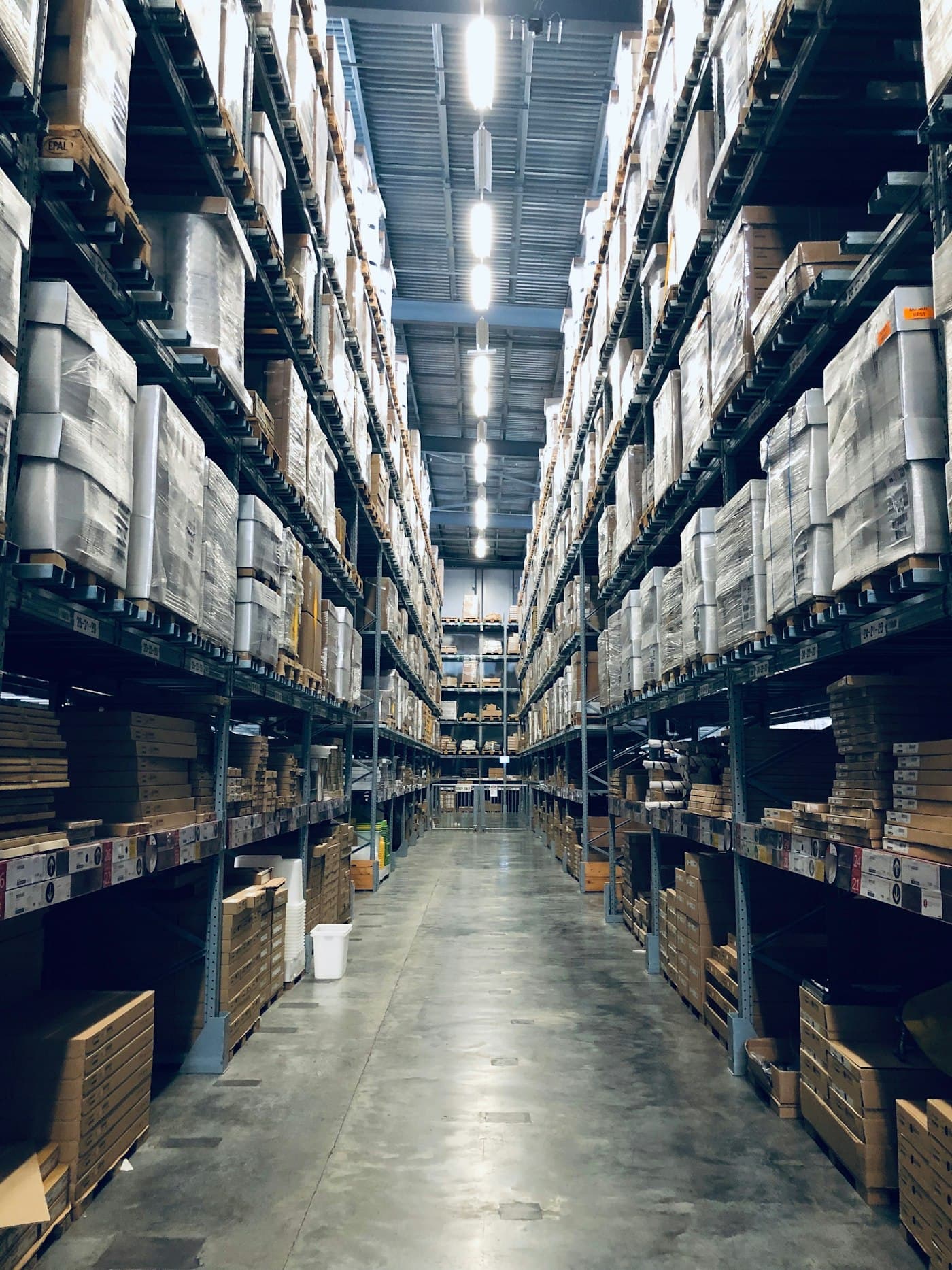 Rows of stocked shelving inside a distribution warehouse